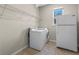 Laundry room features a washer and dryer, a refrigerator, and wire rack shelving at 690 Blue Citrus Ln, Minneola, FL 34715