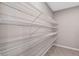 Walk-in pantry with white wire shelving for ample storage space at 690 Blue Citrus Ln, Minneola, FL 34715