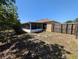 Spacious backyard featuring a screened in lanai, privacy fencing, and lush landscaping perfect for outdoor activities at 712 Leonardo Ct, Kissimmee, FL 34758