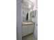 Bathroom vanity with granite countertop, modern lighting, and stylish fixtures at 712 Leonardo Ct, Kissimmee, FL 34758