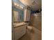 Stylish bathroom with granite counters, updated vanity, and tiled shower with glass doors at 712 Leonardo Ct, Kissimmee, FL 34758