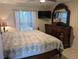 Comfortable bedroom with traditional furniture, a decorative mirror, and a bright window at 712 Leonardo Ct, Kissimmee, FL 34758