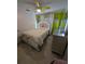 Cozy bedroom with stylish bed frame, ceiling fan, tile floors, and a bright accent wall at 712 Leonardo Ct, Kissimmee, FL 34758