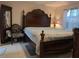 This elegant bedroom boasts a large wooden bed frame and ample natural light from the window at 712 Leonardo Ct, Kissimmee, FL 34758