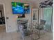 Cozy dining area features a glass table with seating for four and a decorative mirrored console at 712 Leonardo Ct, Kissimmee, FL 34758