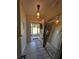 Inviting foyer featuring tile flooring, a decorative mirror, and a view to the outdoors at 712 Leonardo Ct, Kissimmee, FL 34758