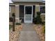 Inviting screened front entrance featuring charming landscaping and decorative touches for a warm welcome at 712 Leonardo Ct, Kissimmee, FL 34758