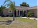 Inviting home featuring a landscaped front yard, healthy lawn, and a covered entryway at 712 Leonardo Ct, Kissimmee, FL 34758