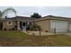 Charming single-story home featuring a well-manicured lawn and decorative landscaping, perfect for curb appeal at 712 Leonardo Ct, Kissimmee, FL 34758