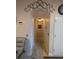 Hallway with neutral color walls, tile floors, decorative clock and overhead lighting at 712 Leonardo Ct, Kissimmee, FL 34758