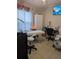 Well-lit office space with an exam table, work station and calming decorative elements at 712 Leonardo Ct, Kissimmee, FL 34758