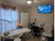 Bright office space set up with an exam table, chair, and calming decorative elements at 712 Leonardo Ct, Kissimmee, FL 34758