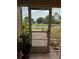 View from inside screened porch towards landscaped yard, offering a serene outdoor living space at 712 Leonardo Ct, Kissimmee, FL 34758