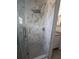 Updated shower with white marble tiles, glass enclosure, and modern shower head at 712 Leonardo Ct, Kissimmee, FL 34758