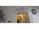 Wall with decorative swirls above a doorway, a clock and lighting fixture are also in view at 712 Leonardo Ct, Kissimmee, FL 34758