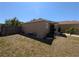 Side yard showcasing the home's exterior, fence, and landscaped border at 712 Leonardo Ct, Kissimmee, FL 34758