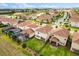 Aerial view displays the rear of multiple properties, highlighting screened patios, tile roofs, and manicured backyards at 8991 Fluffy Lie Ct, Davenport, FL 33896