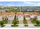 An aerial view of houses showing the manicured lawns, driveways, and uniform architecture in a well-planned community at 8991 Fluffy Lie Ct, Davenport, FL 33896