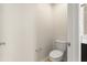 Powder room featuring toilet, vanity with countertop, and modern fixtures at 8991 Fluffy Lie Ct, Davenport, FL 33896