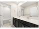 Bright bathroom featuring double sinks, a large mirror, and a separate toilet and shower area at 8991 Fluffy Lie Ct, Davenport, FL 33896