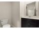Bathroom featuring a modern vanity, mirror, and toilet at 8991 Fluffy Lie Ct, Davenport, FL 33896