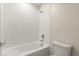 Clean and functional bathroom featuring a white tiled shower-tub combination with modern fixtures at 8991 Fluffy Lie Ct, Davenport, FL 33896