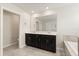 Well-lit bathroom with a double vanity, large mirror, and access to both the toilet room and shower at 8991 Fluffy Lie Ct, Davenport, FL 33896