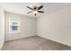 Bedroom featuring neutral walls, carpet flooring, ceiling fan, and a large window at 8991 Fluffy Lie Ct, Davenport, FL 33896
