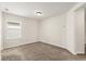 Cozy bedroom with carpet, large window offering natural light, and neutral paint throughout at 8991 Fluffy Lie Ct, Davenport, FL 33896