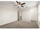 Bedroom featuring a ceiling fan, carpeted floor, a window and an adjoining closet and bathroom at 8991 Fluffy Lie Ct, Davenport, FL 33896