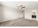 Large bedroom with neutral carpet and a ceiling fan, with an ensuite bathroom and walk-in closet at 8991 Fluffy Lie Ct, Davenport, FL 33896