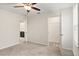Bedroom featuring carpet floors, ceiling fan, window, and an open entrance to the adjoining bathroom and closet at 8991 Fluffy Lie Ct, Davenport, FL 33896
