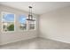 A bright dining area featuring large windows and neutral tile flooring at 8991 Fluffy Lie Ct, Davenport, FL 33896