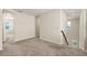 Upstairs hallway with carpet, natural light from windows and a staircase with black handrail at 8991 Fluffy Lie Ct, Davenport, FL 33896