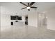 Open-concept kitchen and living area with stainless steel appliances and modern dark cabinets at 8991 Fluffy Lie Ct, Davenport, FL 33896