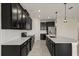 Modern kitchen with stainless steel appliances, an island and dark wood cabinets at 8991 Fluffy Lie Ct, Davenport, FL 33896