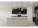 Modern kitchen with stainless steel appliances, an island and dark wood cabinets at 8991 Fluffy Lie Ct, Davenport, FL 33896