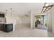 Open concept living space with stainless steel appliances and sliding doors leading to the backyard at 8991 Fluffy Lie Ct, Davenport, FL 33896