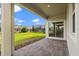 Outdoor patio with brick pavers, a covered area, and a view of the fenced backyard at 8991 Fluffy Lie Ct, Davenport, FL 33896