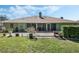 View of backyard featuring a concrete patio, lush lawn, and mature landscaping at 907 Ridge Spring Ct, Apopka, FL 32712