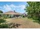 Large backyard featuring a concrete patio and lush landscaping at 907 Ridge Spring Ct, Apopka, FL 32712