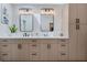 Bright bathroom with double vanity, framed mirrors, light fixtures, and a walk-in closet at 907 Ridge Spring Ct, Apopka, FL 32712