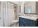 Bathroom featuring a framed mirror, vanity with marble countertop, and shower with white curtain at 907 Ridge Spring Ct, Apopka, FL 32712