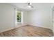 Bright bedroom with hardwood floors, a ceiling fan, and a window at 907 Ridge Spring Ct, Apopka, FL 32712