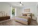 Bright bedroom featuring hardwood floors, a ceiling fan, and natural light from the window at 907 Ridge Spring Ct, Apopka, FL 32712