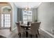Charming dining room featuring a modern chandelier, large window, and designer wallpaper at 907 Ridge Spring Ct, Apopka, FL 32712