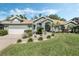 Charming single-story home with a manicured lawn, beautiful landscaping, and inviting curb appeal at 907 Ridge Spring Ct, Apopka, FL 32712