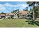 Beautiful single-story home featuring lush green lawns, mature trees, and well-maintained landscaping at 907 Ridge Spring Ct, Apopka, FL 32712