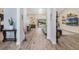 Open-concept hallway showcasing the home's layout, natural light, and stylish wood-look tile flooring at 907 Ridge Spring Ct, Apopka, FL 32712