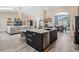 Open concept kitchen with large island, bar seating, and modern appliances at 907 Ridge Spring Ct, Apopka, FL 32712